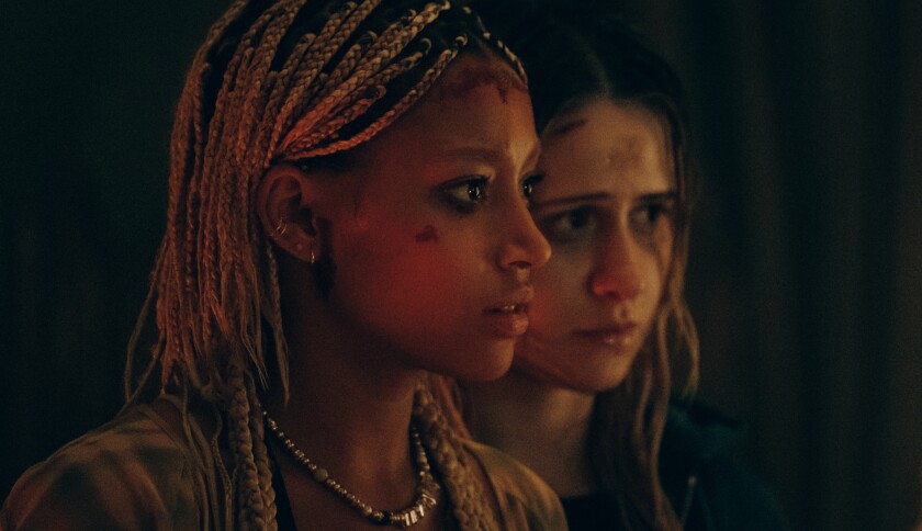 Two women in dark lighting