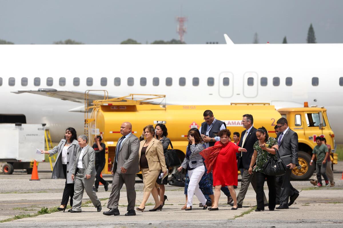Una comitiva del Servicio de Inmigración y Control de Aduanas de Estados Unidos observa a varios deportados bajar de un avión proveniente de Meza, Arizona (EEUU).