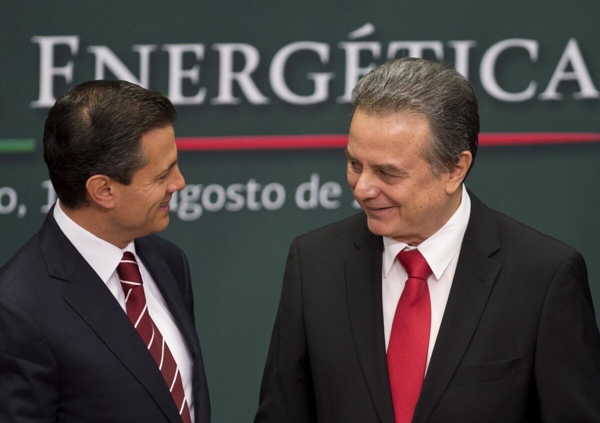 Mexican President Enrique Pena Nieto, left, talks with Energy Secretary Pedro Joaquin Coldwell in Mexico City.