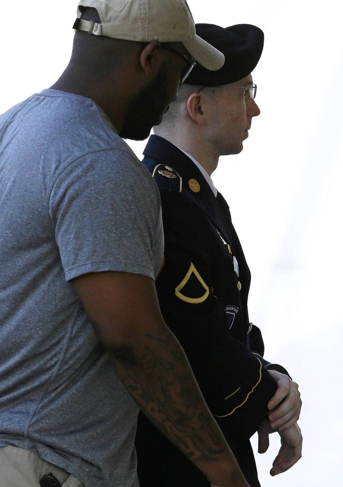 Army Pfc. Bradley Manning is escorted to his court-martial hearing at Ft. Meade, Md.