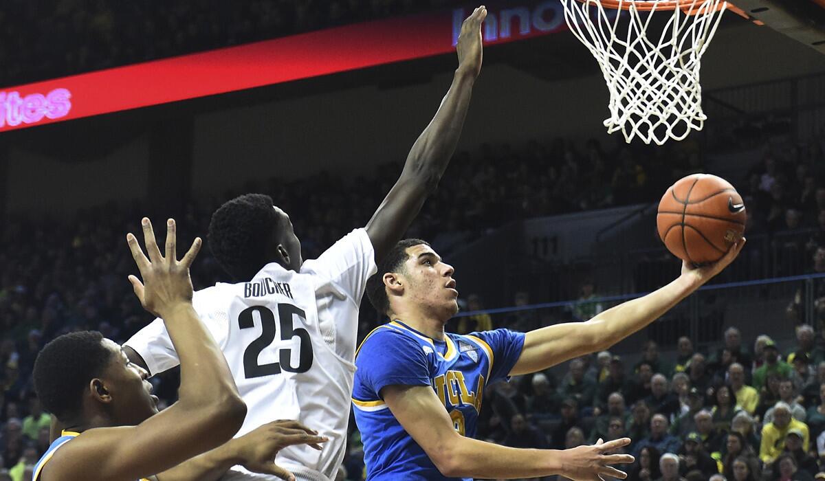 UCLA's Lonzo Ball (2) drives to the basket on Oregon's Chris Boucher (25) during the second half Dec. 28. It was the Bruins' only loss of the season.