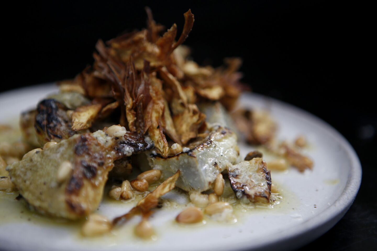 Charred artichoke hearts with fried baby artichokes, toasted pine nut, parmigiano and lemon citronette.