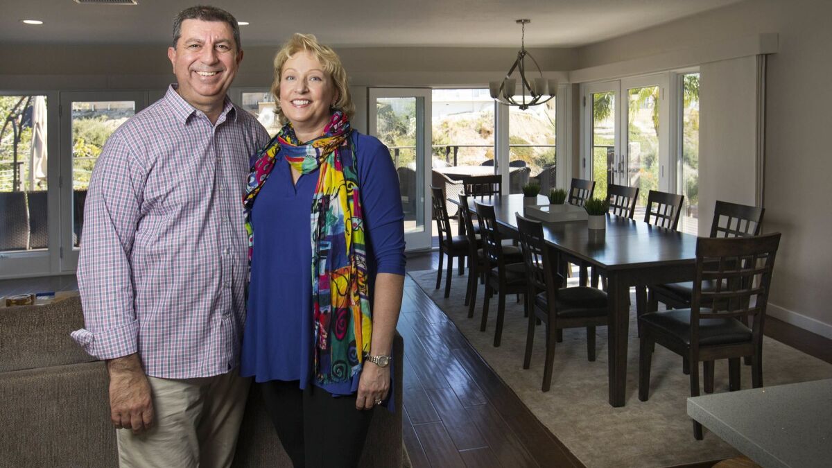 Garo Megerian, left, and his wife, Annette, right, from Pennsylvania, are spending some off time in their La Jolla vacation home that they bought last year and rent out on a short-term basis when they're not there.