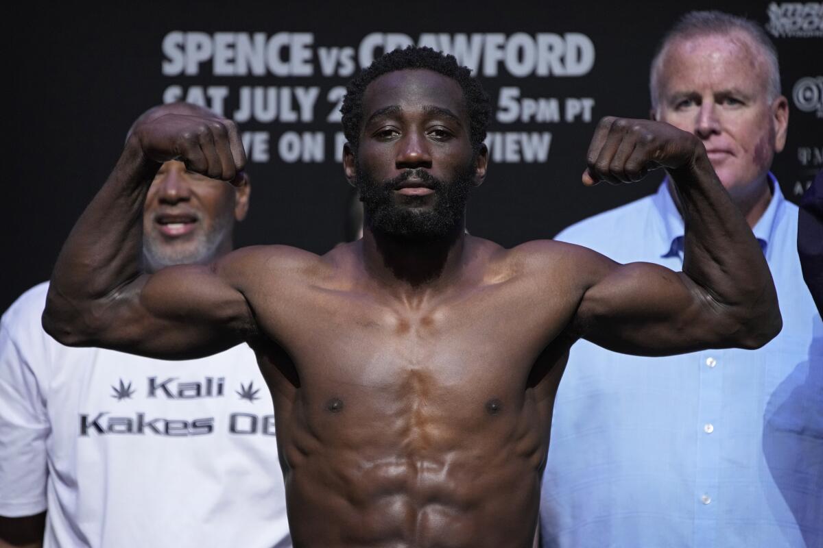 Terence Crawford poses on the scale during a weigh-in Friday in Las Vegas. 