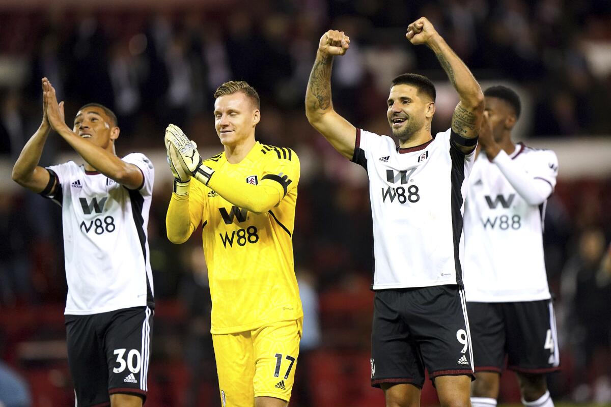 Fulham's Carlos Vinicius, left, goalkeeper Bernd Leno and Aleksandar Mitrovic celebrate after the final whistle of the English Premier League soccer match between Nottingham Forest and Fulham, at The City Ground, Nottingham, England, Friday Sept. 16, 2022. (Tim Good/PA via AP)