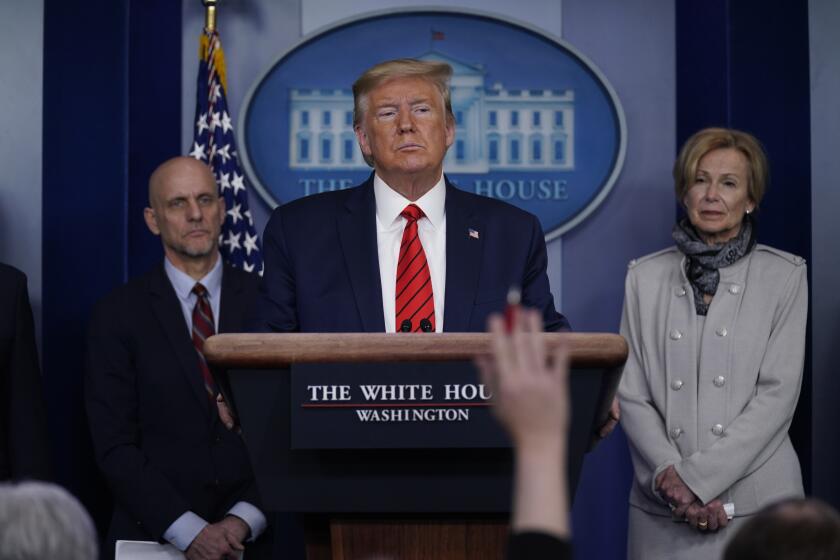 President Donald Trump takes questions during press briefing with the coronavirus task force, at the White House, Thursday, March 19, 2020, in Washington. Food and Drug Administration Commissioner Dr. Stephen Hahn, at left, and Dr. Deborah Birx, White House coronavirus response coordinator, at right listen. (AP Photo/Evan Vucci)