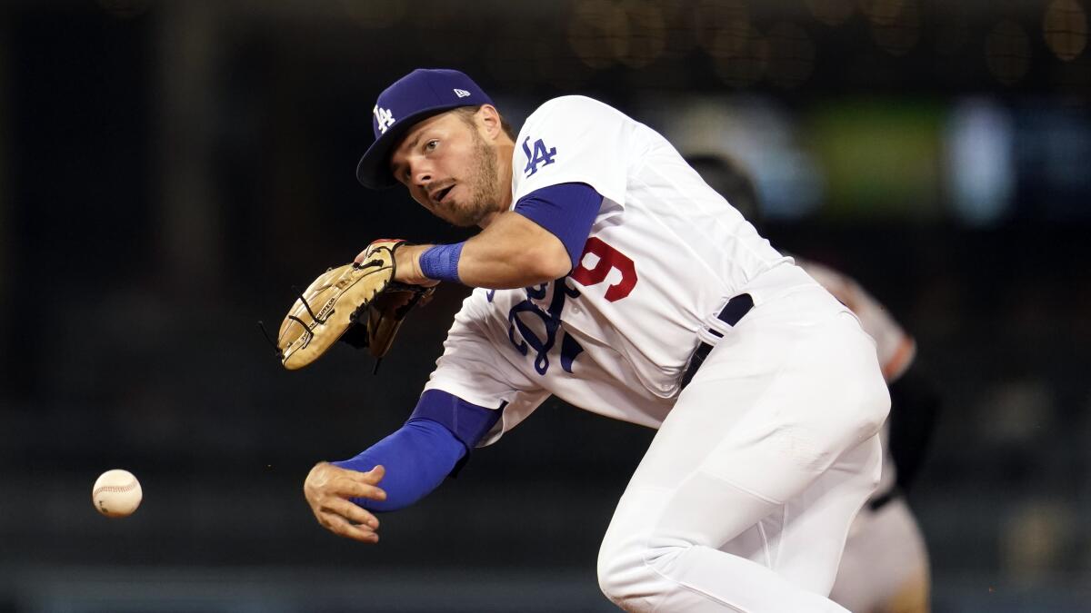 Dodgers second baseman Gavin Lux makes an off-balance throw to first base against the San Francisco Giants on July 22.