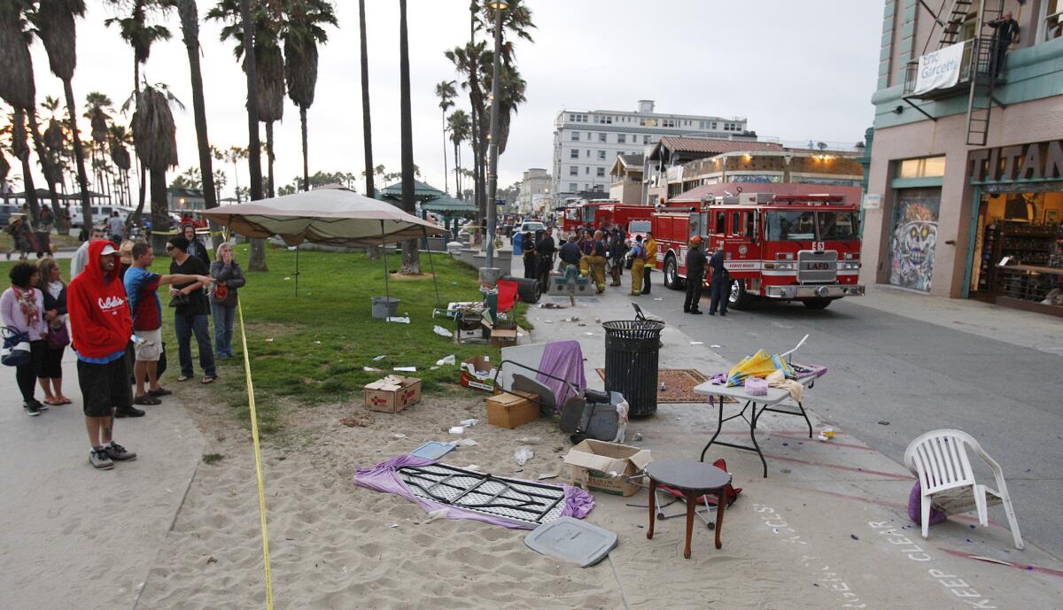 Debris litters the scene after a person drove a car onto the crowded Venice boardwalk and struck several people Saturday, killing one and injuring 16.