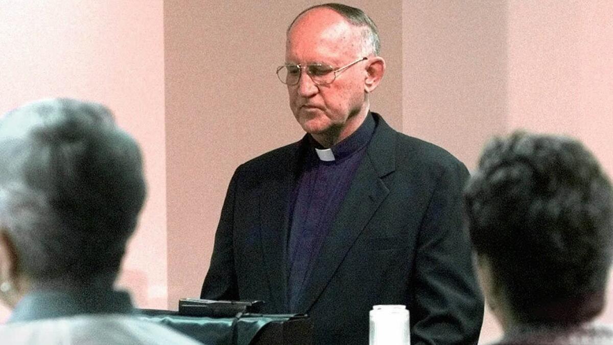 Bishop Charles V. Grahmann leads a prayer in the Catholic Diocese of Dallas chancery chapel at the beginning of a 1998 news conference on a child sex abuse civil settlement.