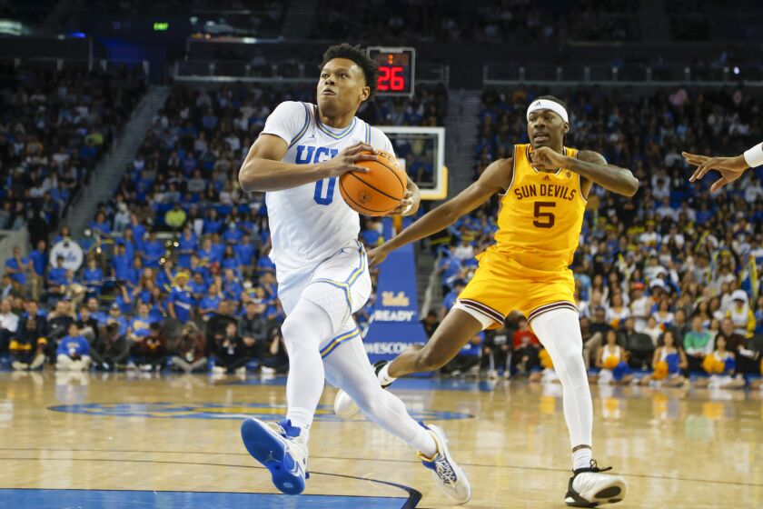 UCLA guard Jaylen Clark (0) drives past Arizona State forward Jamiya Neal (5) during the second half of an NCAA college basketball game Thursday, March 2, 2023, in Los Angeles. UCLA won 79-61. (AP Photo/Ringo H.W. Chiu)