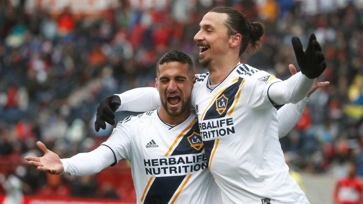 Zlatan Ibrahimovic celebrates with Sebastian Lletget after scoring against the Chicago Fire during the first half on April 14.