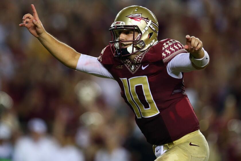 Florida State quarterback Sean Maguire celebrates the Seminoles' overtime win over Clemson on Saturday.