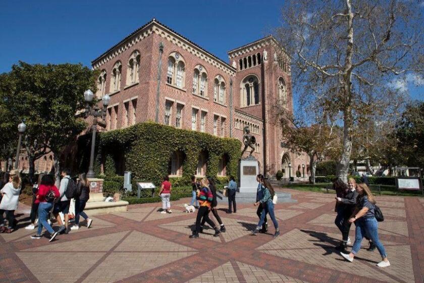 LOS ANGELES, CALIF. -- TUESDAY, MARCH 12, 2019: A view of people visiting the University of Southern California in Los Angeles, Calif., on March 12, 2019. Federal prosecutors say their investigation dubbed Operation Varsity Blues blows the lid off an audacious college admissions fraud scheme aimed at getting the children of the rich and powerful into elite universities. According to prosecutors, wealthy parents paid a firm to help their children cheat on college entrance exams and falsify athletic records of students to enable them to secure admission to schools such as UCLA, USC, Stanford, Yale and Georgetown. Two USC athletic department employees — a high-ranking administrator and a legendary head coach — were fired Tuesday after being indicted in federal court in Massachusetts for their alleged roles in a racketeering conspiracy that helped students get into elite colleges and universities by falsely designating them as recruited athletes. (Allen J. Schaben / Los Angeles Times)