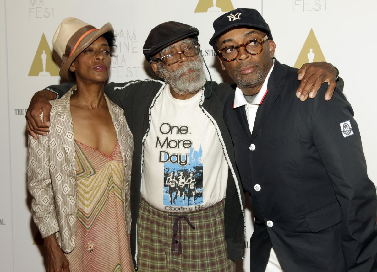 Jazz bassist Bill Lee stands center with daughter Joie Lee, left, and son Spike Lee, right