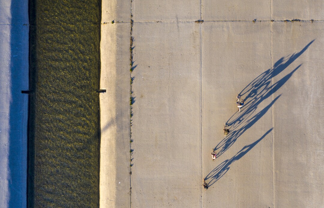 Cyclists ride in the Los Angeles River Sunday.