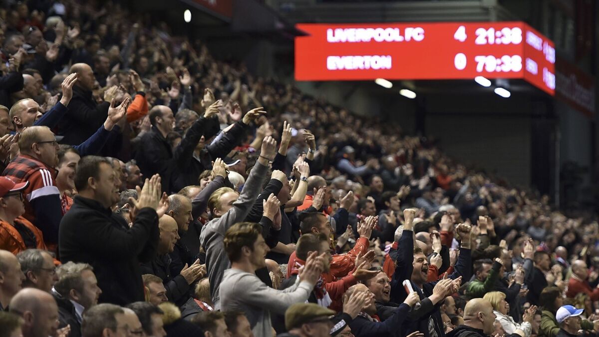 Liverpool fans react during the Barclays Premier League match against Everton at Anfield on April 20.