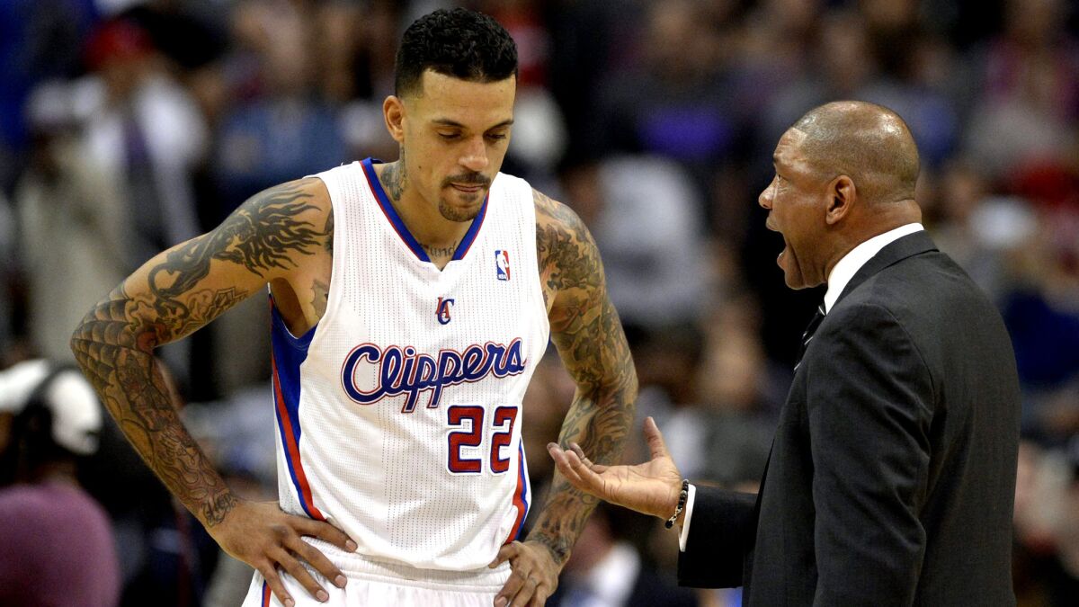 Clippers Coach Doc Rivers talks to forward Matt Barnes during a game Jan. 15, 2014.