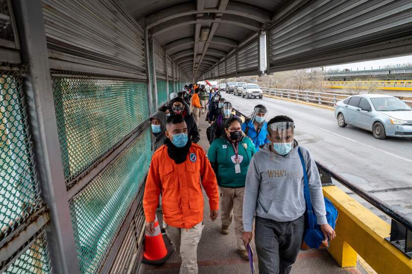  Migrants approach the US border on Gateway International Bridge in Brownsville, Texas.