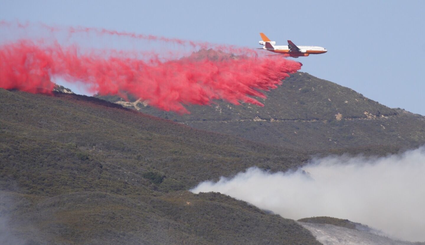 Helicopters drop water while fixed wing aircraft drop Phos Chek to contain the erratic SherpaFire Thursday afternoon near the top of Refugio Road in the Santa Ynez mountains near the Ronald Reagan Ranch above the El Capitan Ranch area west of Goleta.