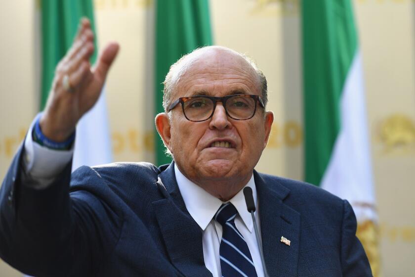 (FILES) In this file photo taken on September 24, 2019, lawyer Rudy Giuliani speaks to the Organization of Iranian American Communities during their march to urge "recognition of the Iranian people's right for regime change," outside the United Nations Headquarters in New York. - Two Ukrainian-born men linked to efforts by US President Donald Trump's lawyer, Rudy Giuliani, to get Ukraine to investigate 2020 Democratic presidential candidate Joe Biden have been arrested for campaign finance violations, The Wall Street Journal reported on October 10, 2019. Lev Parnas and Igor Fruman were arrested on October 9 on charges brought by New York prosecutors and were to appear in court in Virginia on October 10, the newspaper said. The two men both made large donations to a pro-Trump fundraising committee and are facing criminal charges of violating campaign finance rules, the Journal said. (Photo by Angela Weiss / AFP) (Photo by ANGELA WEISS/AFP via Getty Images) ** OUTS - ELSENT, FPG, CM - OUTS * NM, PH, VA if sourced by CT, LA or MoD **