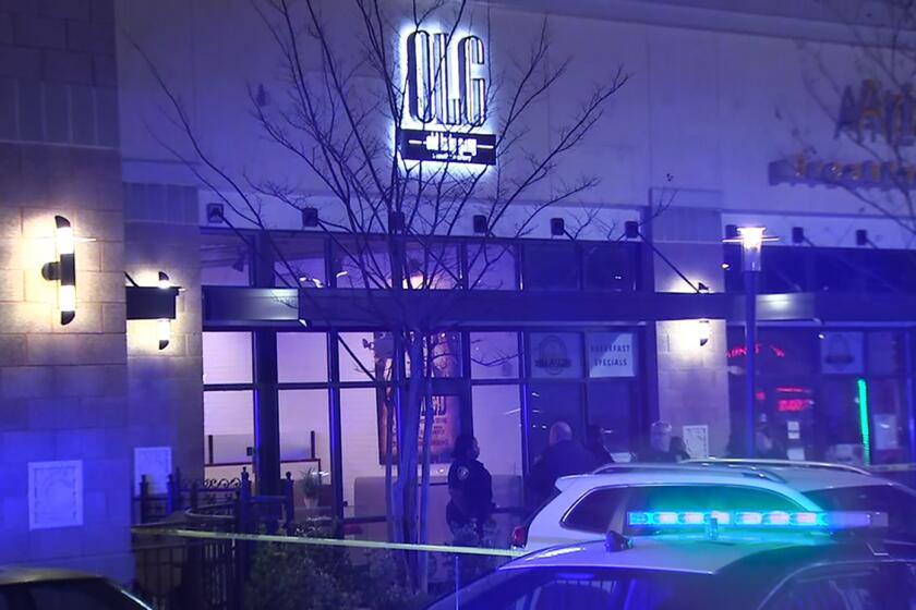 In this image from video provided by WSB-TV, police officers stand outside Old Lady Gang restaurant Friday, Feb. 14, 2020, in East Point, Ga. Three people were shot and wounded at the restaurant just outside Atlanta that's owned by singer and “Real Housewives of Atlanta” star Kandi Burruss. A man entered the Old Lady Gang restaurant and targeted another man, East Point police Capt. Allyn Glover told news outlets. Police say two bystanders were also shot, and all three shooting victims suffered non-life-threatening injuries. (WSB-TV via AP)