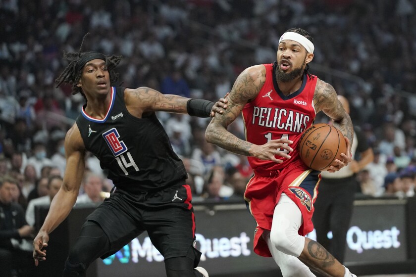 New Orleans Pelicans forward Brandon Ingram, right, drives past Los Angeles Clippers guard Terance Mann during the first half of an NBA basketball play-in tournament game Friday, April 15, 2022, in Los Angeles. (AP Photo/Mark J. Terrill)