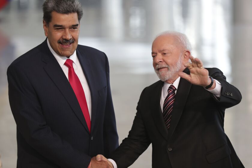 Brazilian President Luiz Inacio Lula da Silva, right, shakes hands with Venezuela's President Nicolas Maduro prior to their bilateral meeting at Planalto palace in Brasilia, Brazil, Monday, May 29, 2023. Maduro is in Brazil for the Union of South American Nations (UNASUR) summit that starts on Tuesday. (AP Photo/Gustavo Moreno)