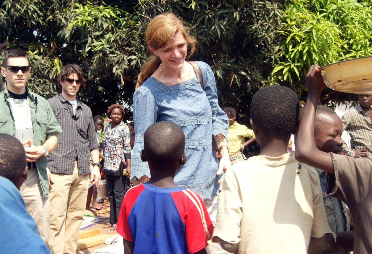 U.S. Ambassador to the United Nations Samantha Power speaks with children in a refugee camp near Bangui's airport after arriving in the Central African Republic.