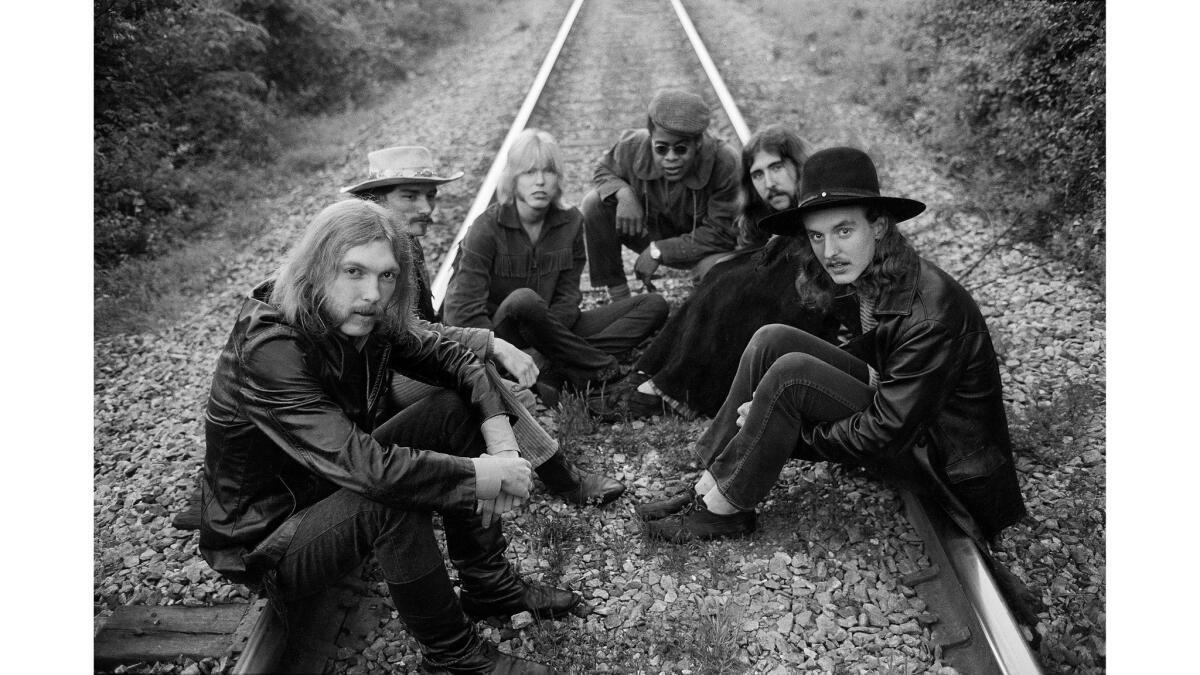 (L-R) Duane Allman, Dickey Betts, Gregg Allman, Jai Johanny Johanson, Berry Oakley and Butch Trucks sit on some railroad tracks May 5, 1969 outside of Macon, Georgia.