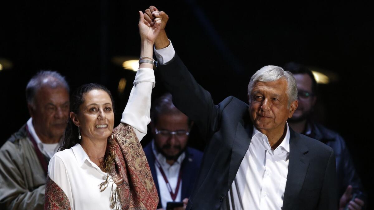 Then-presidential candidate Andres Manuel Lopez Obrador and Mexico City mayoral candidate Claudia Sheinbaum hold their closing campaign rally in Mexico's capital on June 27, 2018.