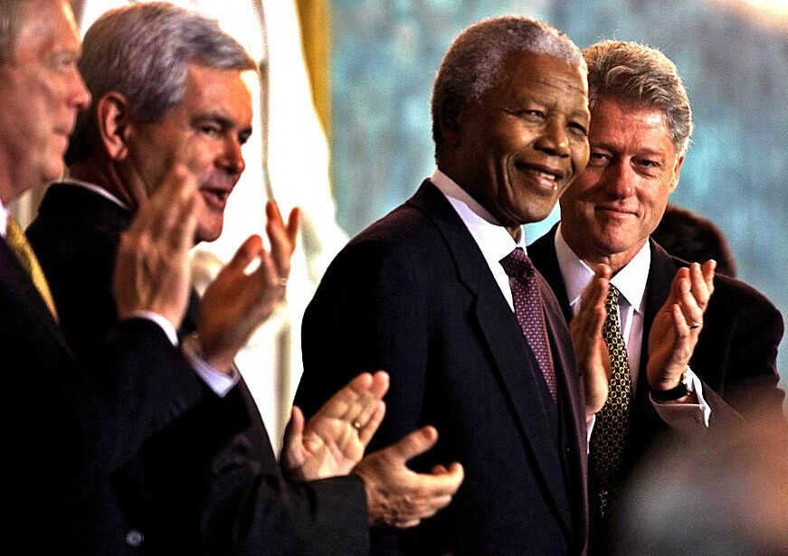 U.S. Rep. Richard Gephardt, left, House Speaker Newt Gingrich and President Clinton welcome President Mandela during a 1998 visit to Washington.