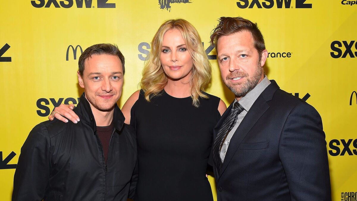 James McAvoy and Charlize Theron join director David Leitch, right, at the "Atomic Blonde" premiere at SXSW in Austin.