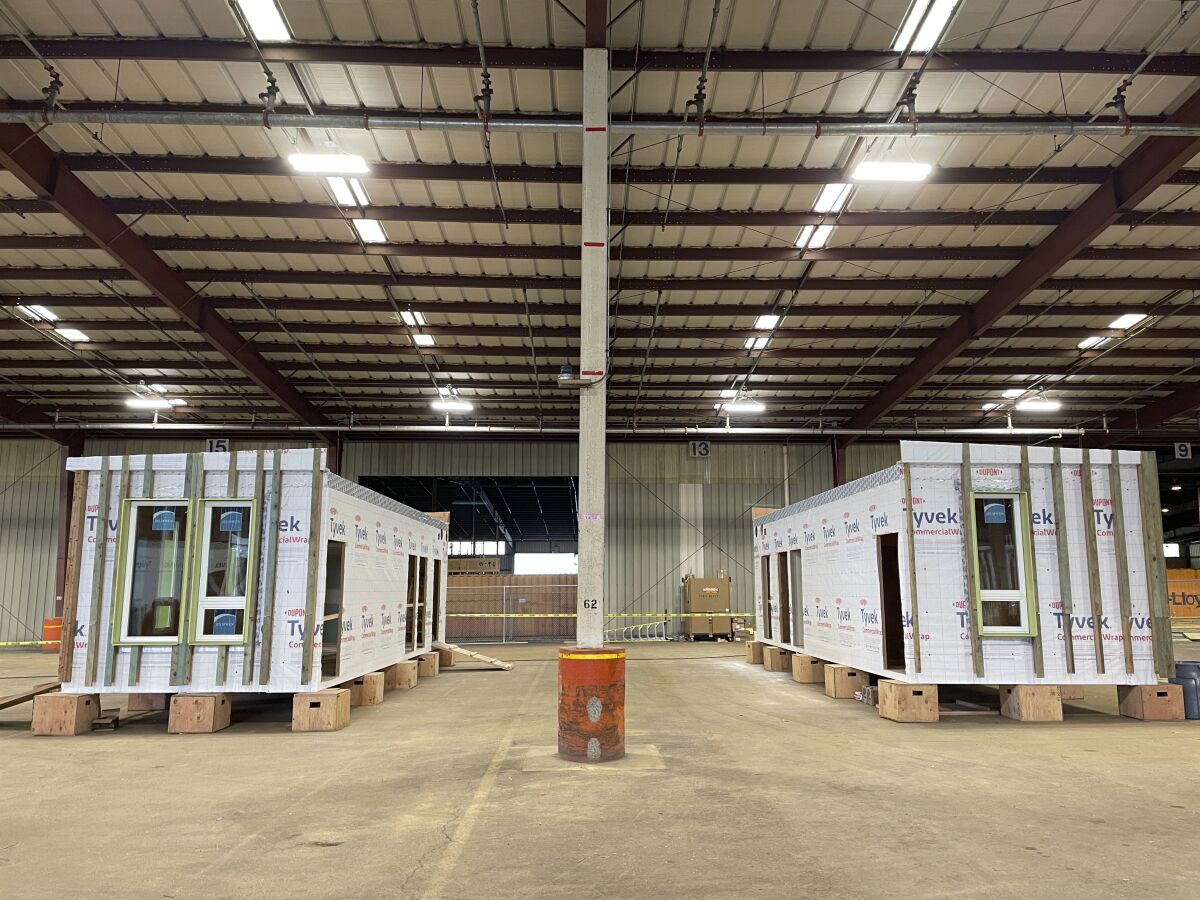 Mass timber affordable home prototypes are shown at the Port of Portland in Portland, Ore. Friday, Jan. 27, 2023. The prototype was built in a warehouse at the port. The Oregon Mass Timber Coalition aims to open a factory at the site that could mass produce homes and potentially alleviate the state's housing shortage. (AP Photo/Claire Rush)