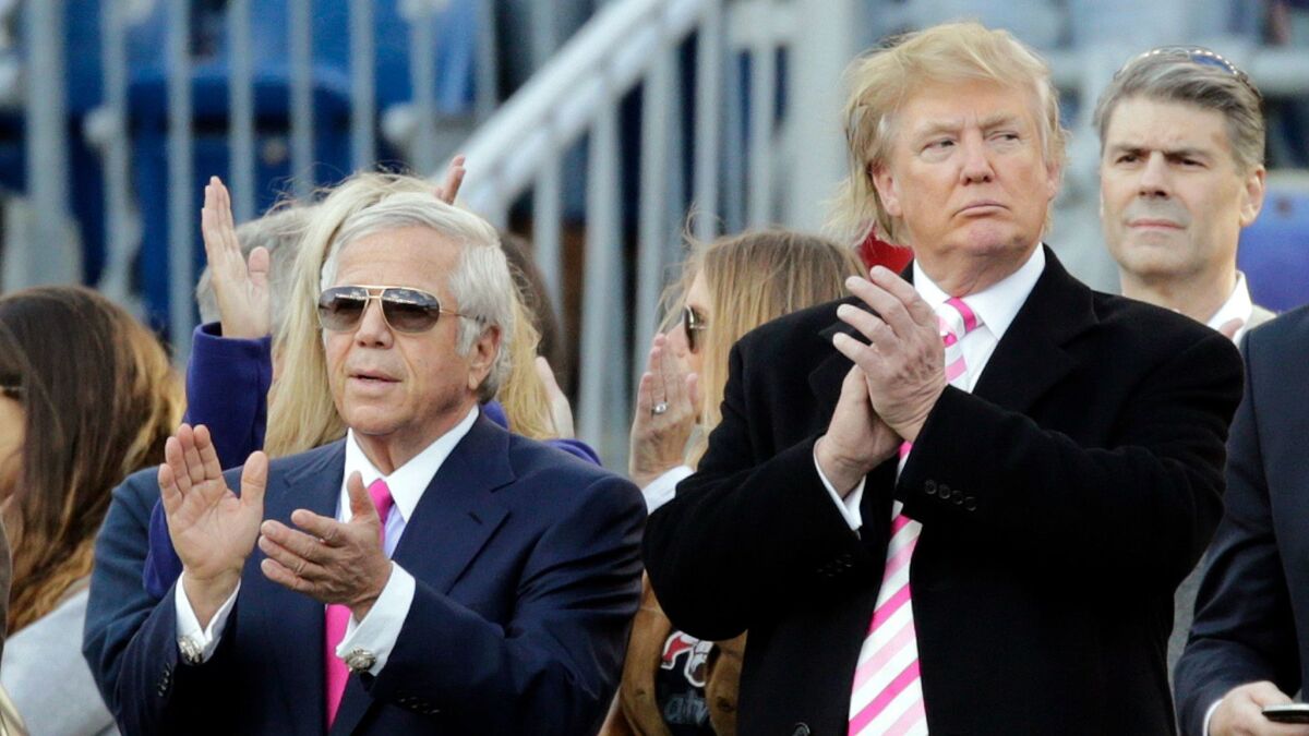 New England Patriots owner Robert Kraft, left, and businessman Donald Trump, right, applaud on the field before an NFL football game between the Patriots and the New York Jets in Foxborough, Mass in 2012.