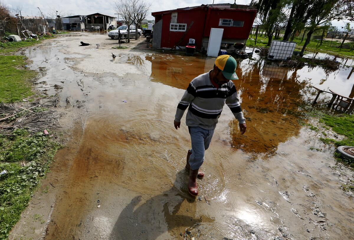 Floodwater flows around a residence in Allensworth, a hamlet in the San Joaquin Valley.  