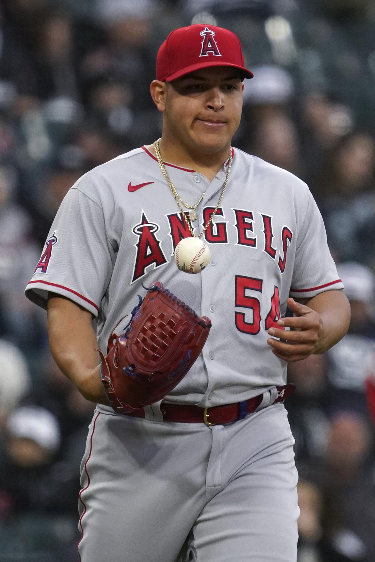 Angels starting pitcher Jose Suarez tosses the ball to himself.