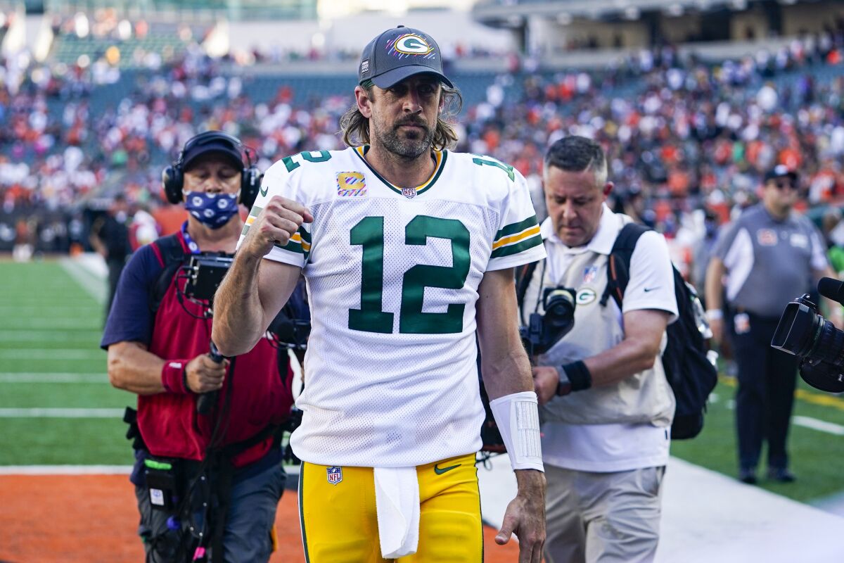 Green Bay Packers quarterback Aaron Rodgers (12) pumps his fist as he leaves the field following an NFL football game against the Cincinnati Bengals in Cincinnati, Sunday, Oct. 10, 2021. (AP Photo/Bryan Woolston)