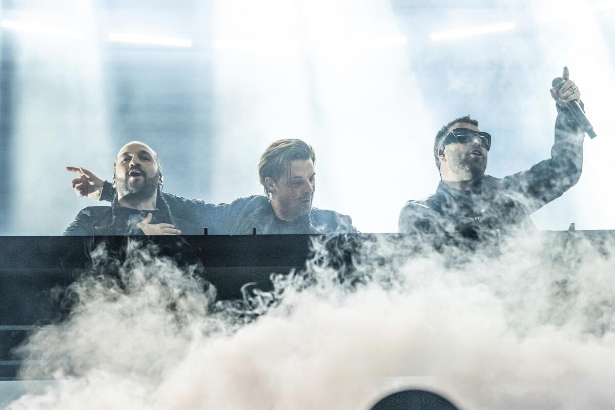 Steve Angello, left, Axwell, and Sebastian Ingrosso of Swedish House Mafia performs at the Coachella Music & Arts Festival