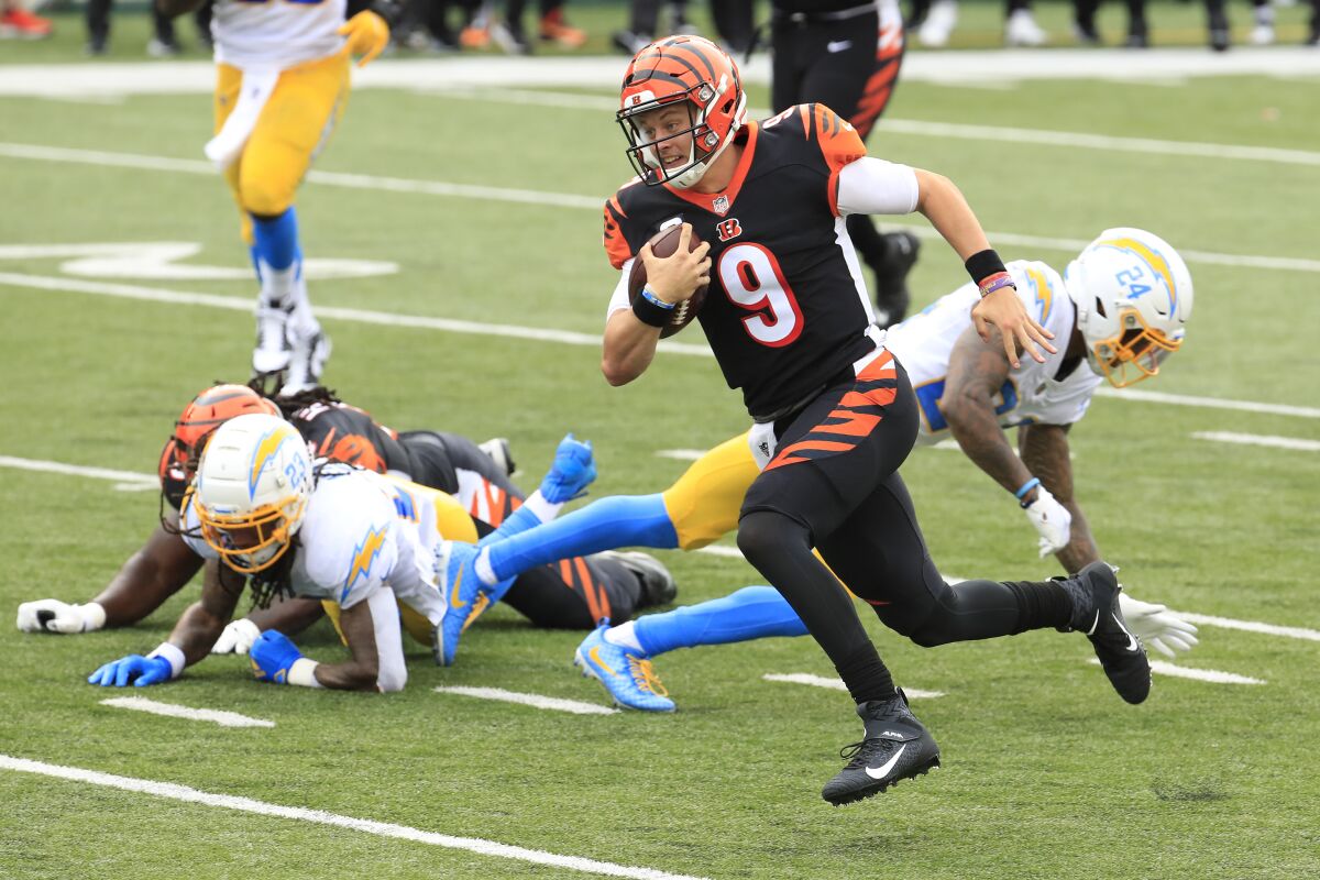 Bengals rookie quarterback Joe Burrow  runs past the Chargers for his first career touchdown.