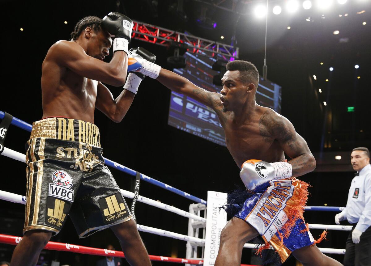 Jermell Charlo tries to land an overhand right against John Jackson during their WBC super-welterweight title fight on Saturday in Las Vegas.