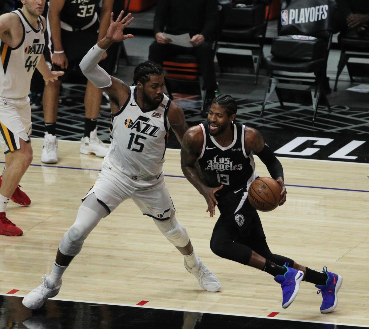 The Clippers' Paul George drives to the basket against the Utah Jazz's Derrick Favors in the second half June 12, 2021.