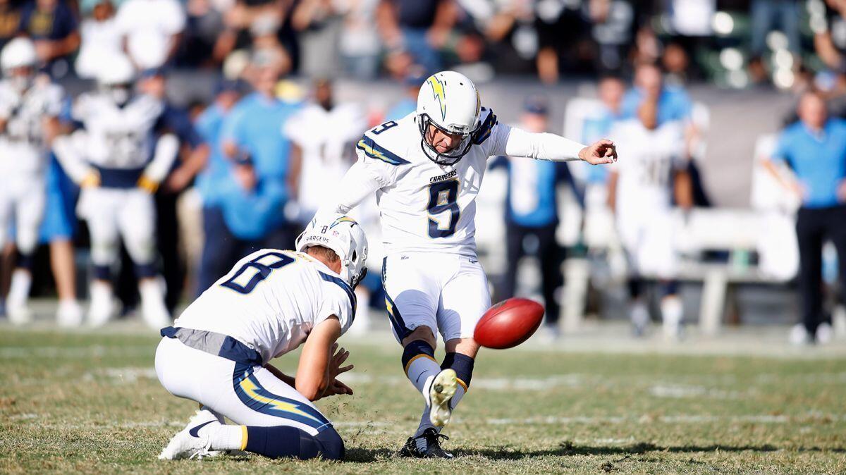 Chargers kicker Nick Novak (9) kicks the game-winning field goal from the hold of Drew Kaser against the Oakland Raiders during the second half on Sunday.