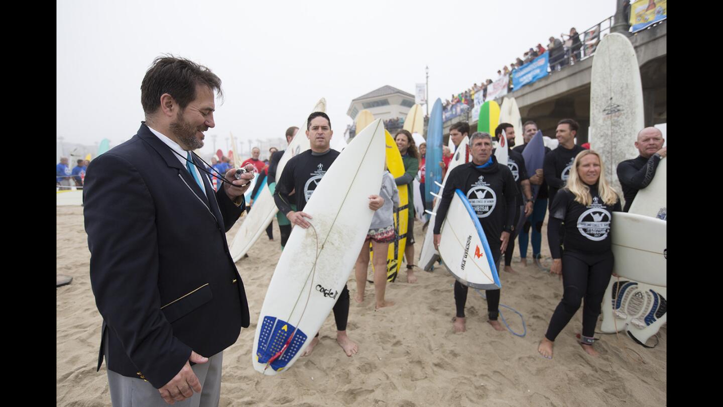 Photo Gallery: 500 surfers paddle out for a record-setting attempt to promote Huntington Beach for the 2024 Olympics