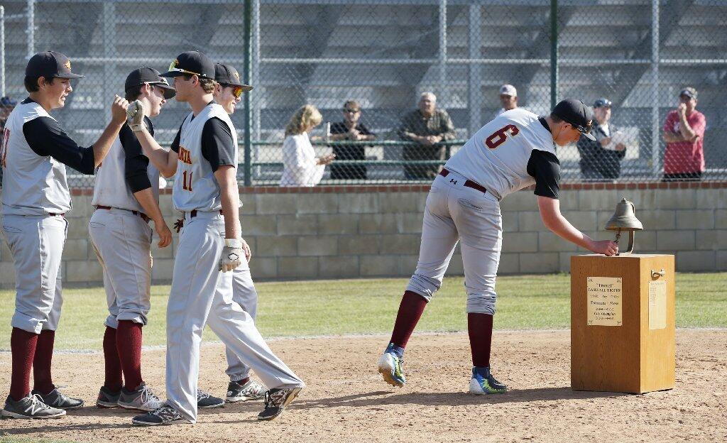 Estancia High's Nic Mazur rings the bell after a 4-1 victory over Costa Mesa in the Battle for the Bell baseball game against Costa Mesa on Friday.