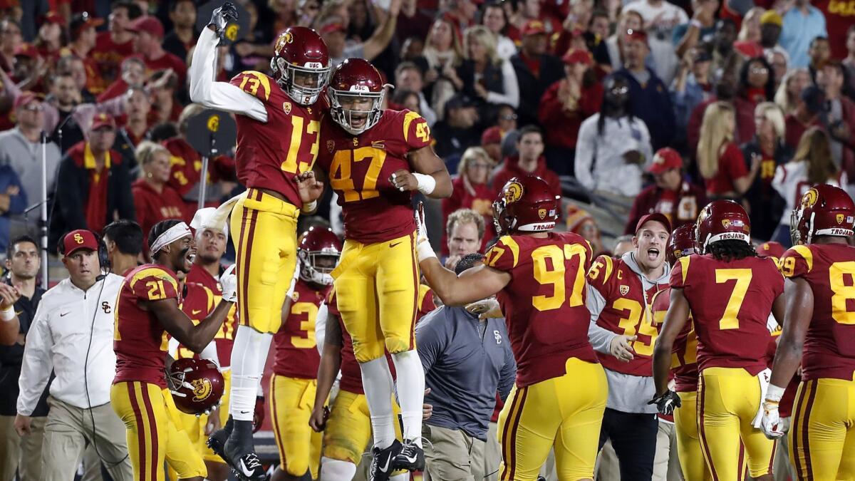 The USC sideline celebrates after the Trojans defense forced a turnover on downs against Colorado on Oct. 13.
