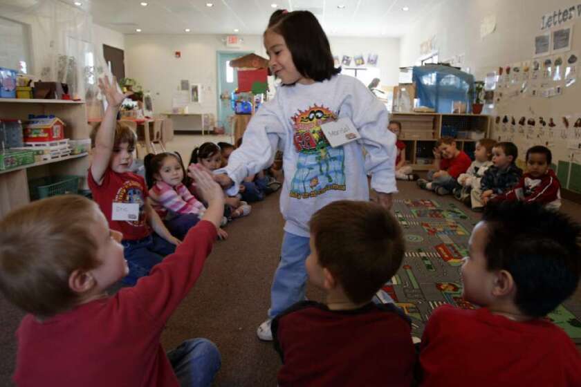 Marisol Paez, 4, high-fives her classmates at Valley View Elementary Preschool in Nuevo, Calif., in 2006. Valley View was the state's first universal preschool, which means all students can attend, regardless of income.