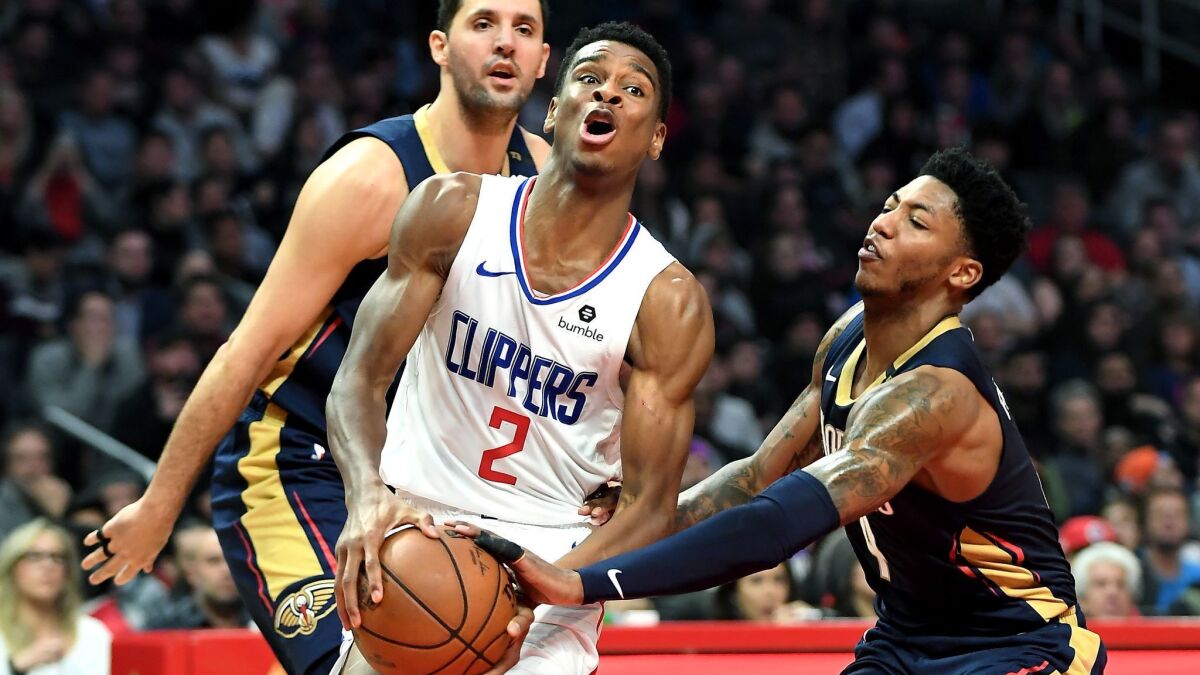 Clippers guard Shai Gilgeous-Alexander drives past Pelicans guard Elfrid Payton, right, and forward Nikola Mirotic during the second quarter Monday.