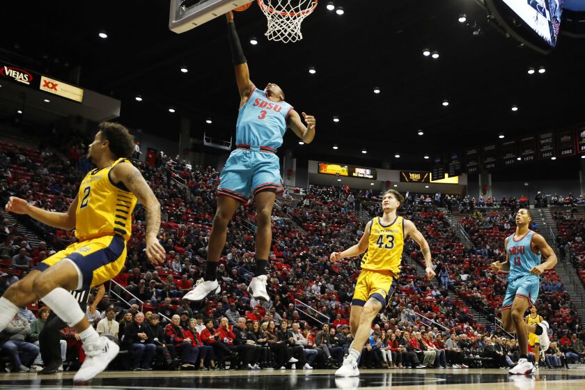 San Diego, CA - November 29: San Diego State's Micah Parrish scores over UC Irvine's Justin Hohn, left, at Viejas Arena on Tuesday, November 29, 2022. (K.C. Alfred / The San Diego Union-Tribune)