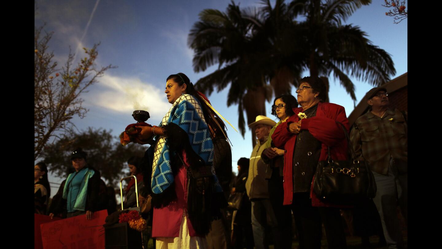 Xochitl, 31, who gave only one name, leads a group of community members in a vigil in memory of Gabriela Calzada and Briana Gallegos, who were found dead in nearby Ernest E. Debs Regional Park. Their deaths, which took place in late October, have been ruled homicides, and investigators are still looking for suspects.
