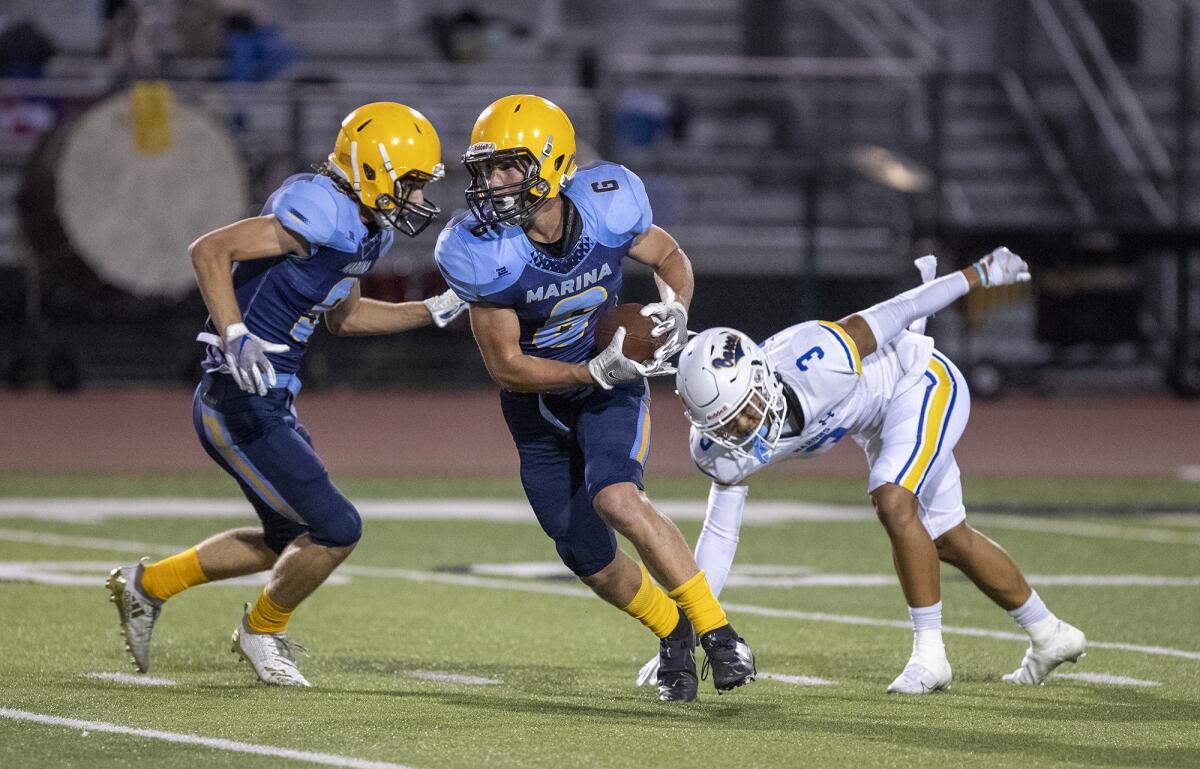 Marina's Aidan O'Callaghan breaks a tackle by a Fountain Valley player during a nonleague game on Sept. 10.